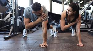 Toning Bingo Wings: Your Ultimate Guide to Sculpting Sleek Arms at the Gym 3 Fitness trainer demonstrating arm toning exercises Wimborne